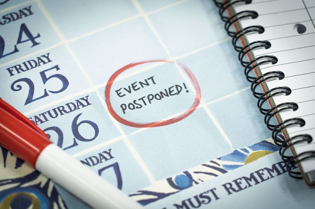 A calendar with the note “Event postponed” circled in red marker