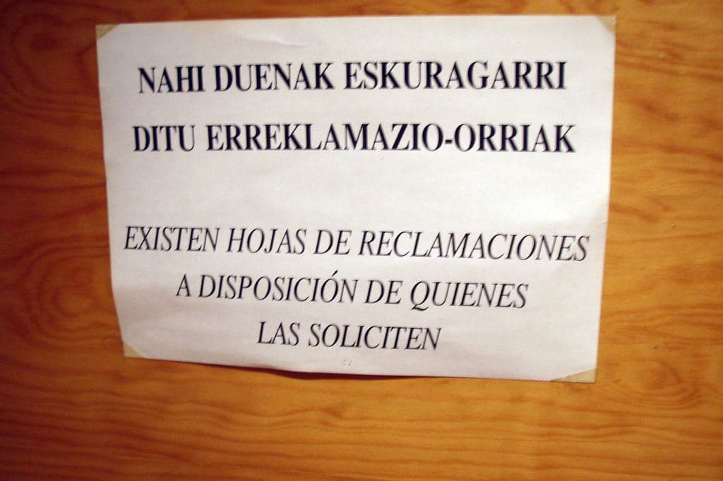 A sign stating that official complaint forms are available on request