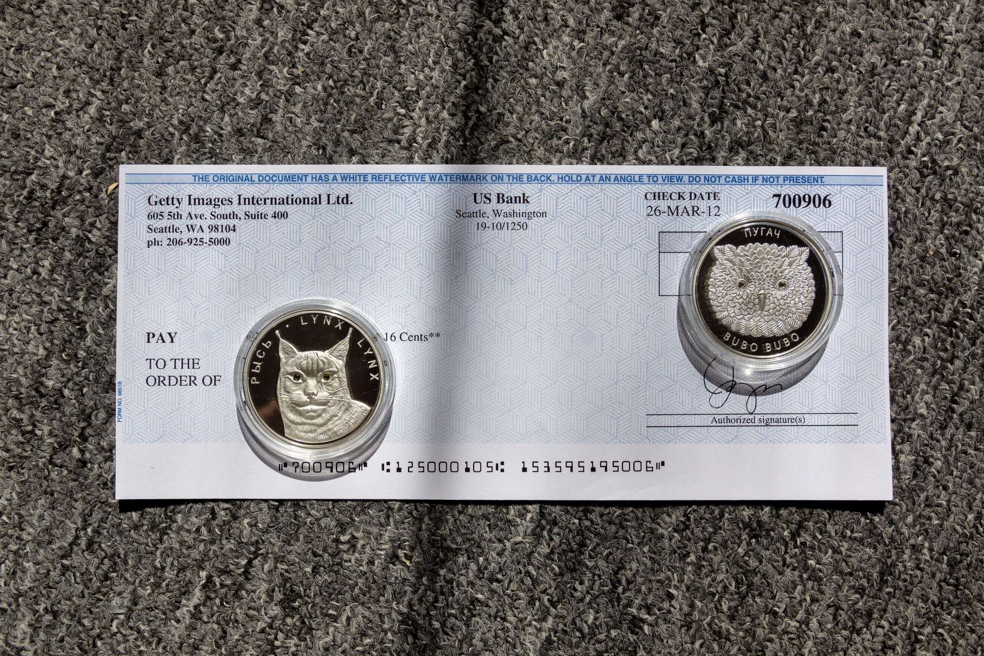 A bank check with coins on top