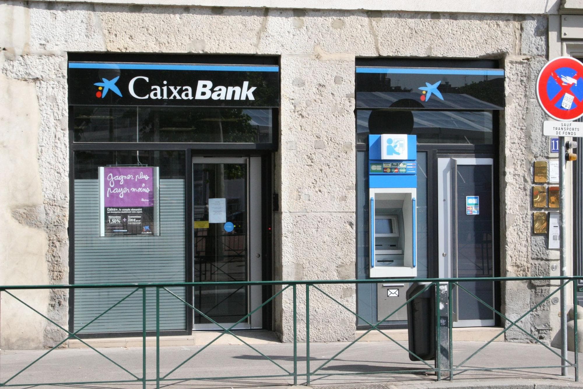 The entrance to a CaixaBank branch on a street